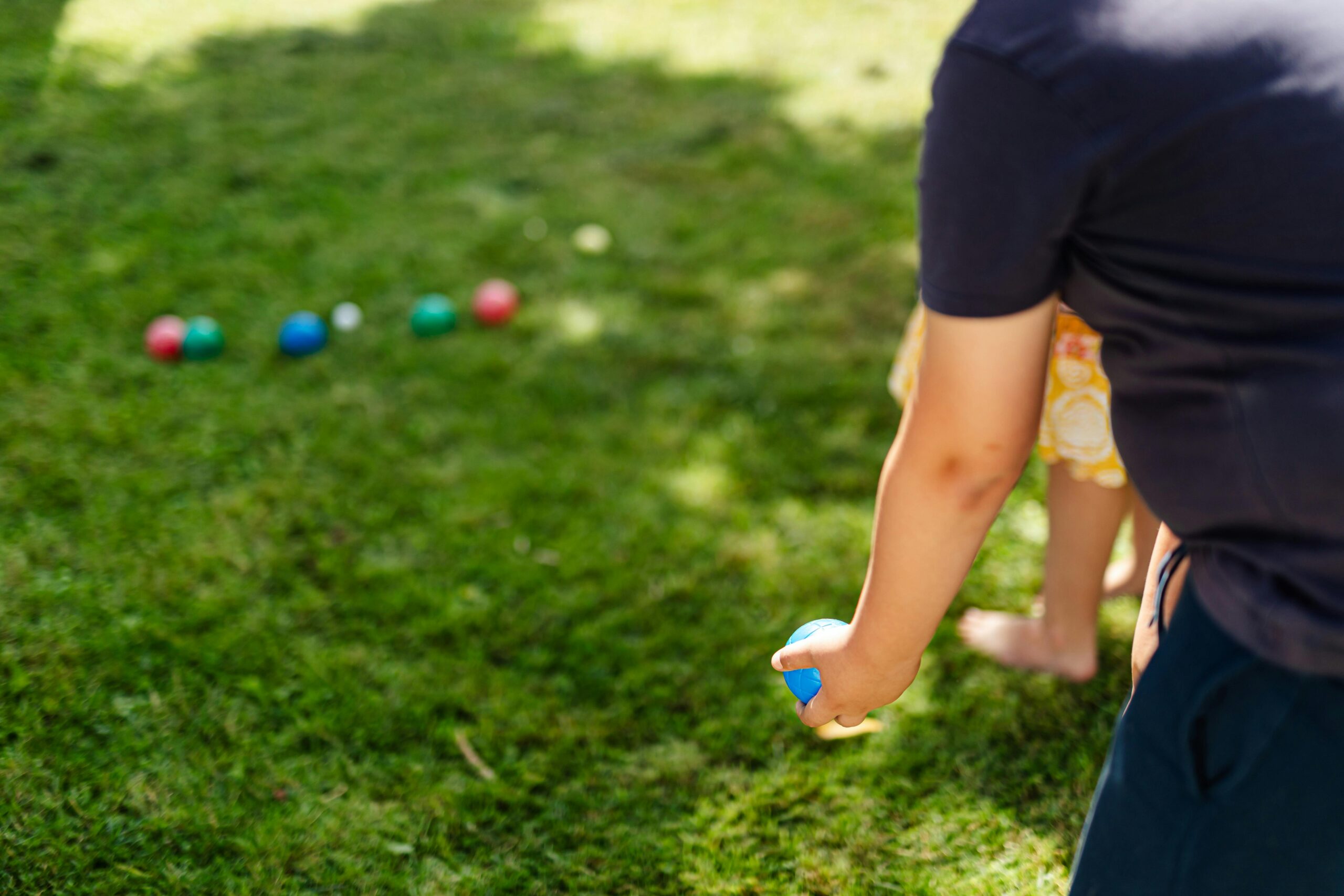 Family playing lawn bowling
